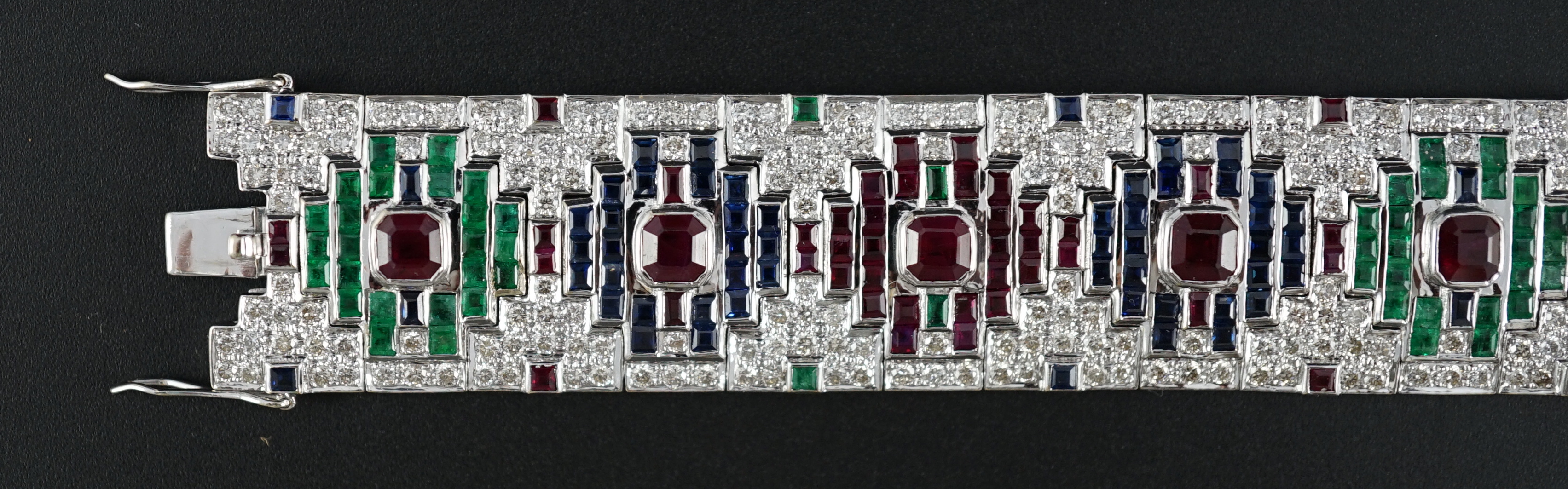 An attractive late 20th century 18k white gold, ruby, sapphire, emerald and diamond set bracelet